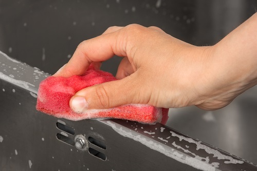 Person Cleaning a Steel Surface